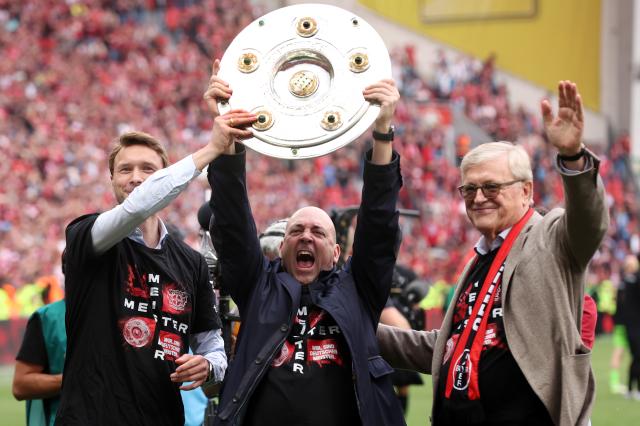 Simon Rolfes, Fernando Carro, and Werner Wenning hoist the Meisterschale last Spring.