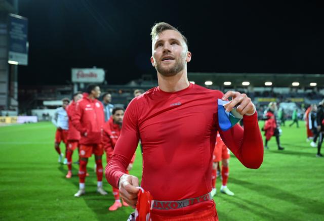 Mainz 05 captain Silvan Widmer heads to the FAnKurve following an away win at Kiel. 